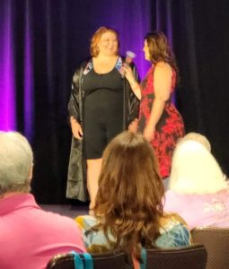 Plus size Model wearing long denim dress at a fashion show.